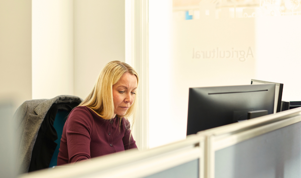 Commercial Agency Image Acquisitions - team member working at desk in norwich office