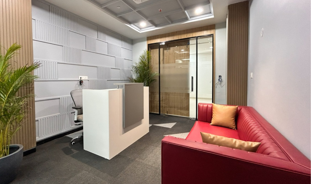 Commercial Property Management Page image of a reception in a commercial office building with a bright red sofa