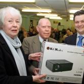 Barry Cooke of Arnolds Keys right presents the projector to Cringleford Historical Society chairman David Welch and secretary Pat Wagstaff 620x413