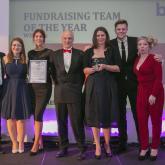 The Arnolds Keys staff charity committee receiving their award from Jake Humphrey