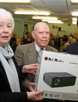 Barry Cooke of Arnolds Keys right presents the projector to Cringleford Historical Society chairman David Welch and secretary Pat Wagstaff 620x413