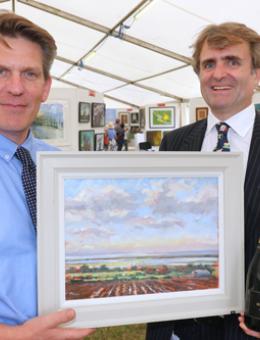 RNS Art Exhibition head steward Tom Cringle and Guy Gowing from Arnolds Keys with the winning picture 500px